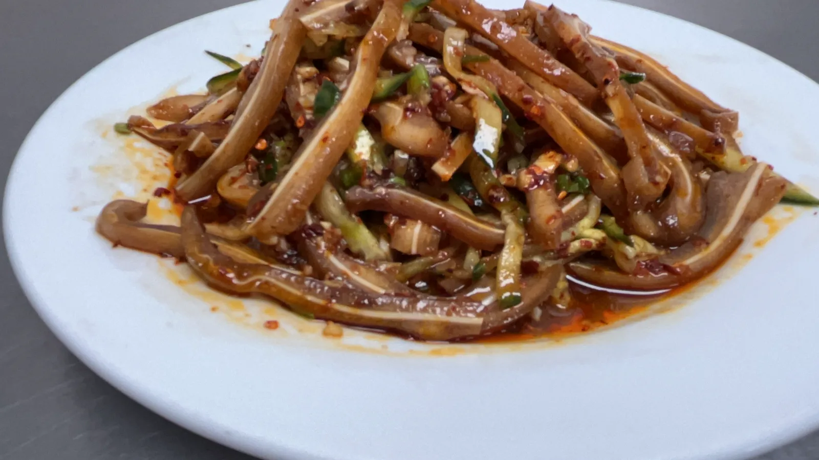 DL Eats spicy pig ear salad with cucumber, chilli oil and fresh herbs